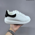 Alexander McQueen Oversized White Low-Cut Sneakers with Black Heel - product image from the listing.