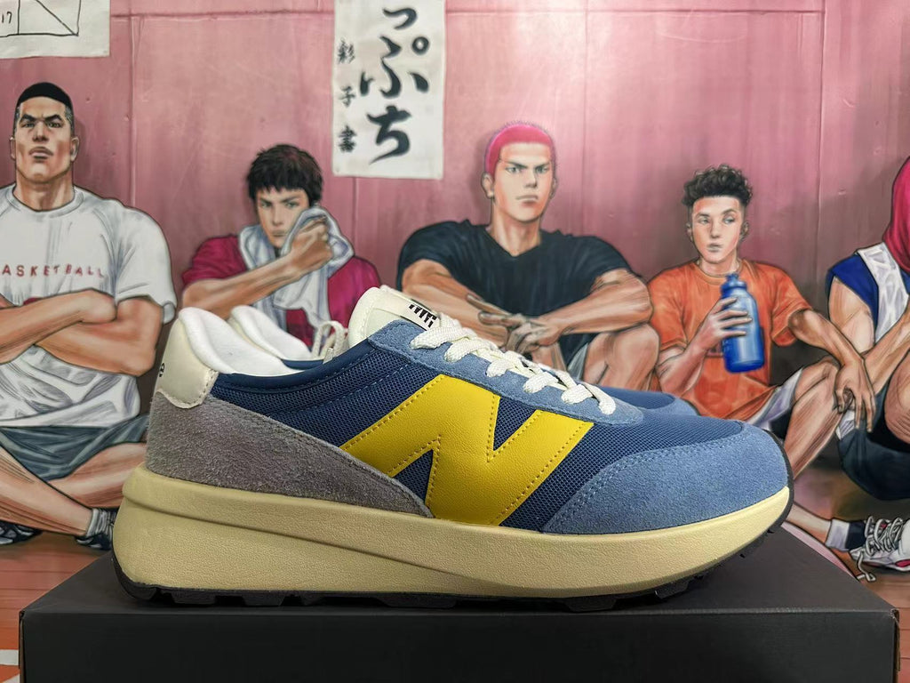 New Balance U370 Sneakers in Blue and Yellow - product image from the listing.