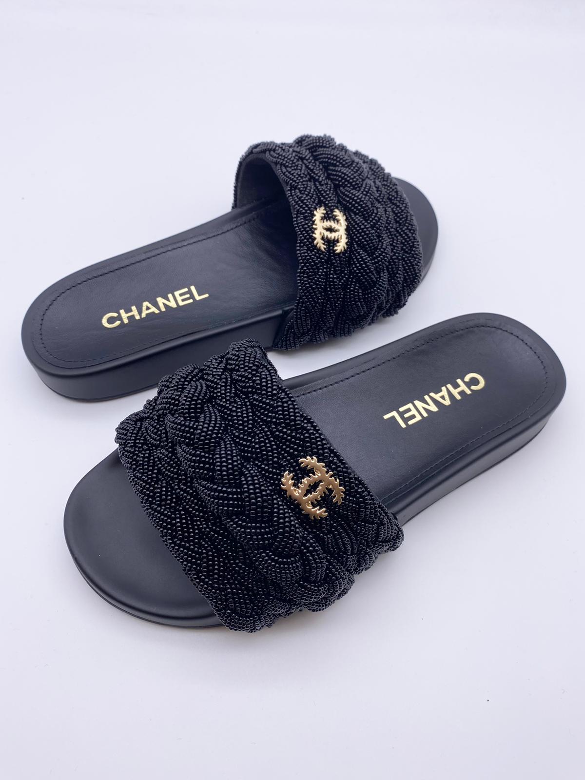 Chanel Pearl & Lambskin Woven Mule Slides in Black - product image from the listing.